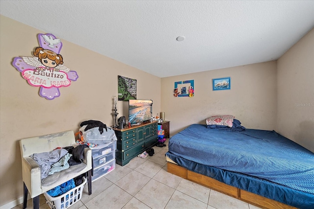 tiled bedroom featuring a textured ceiling