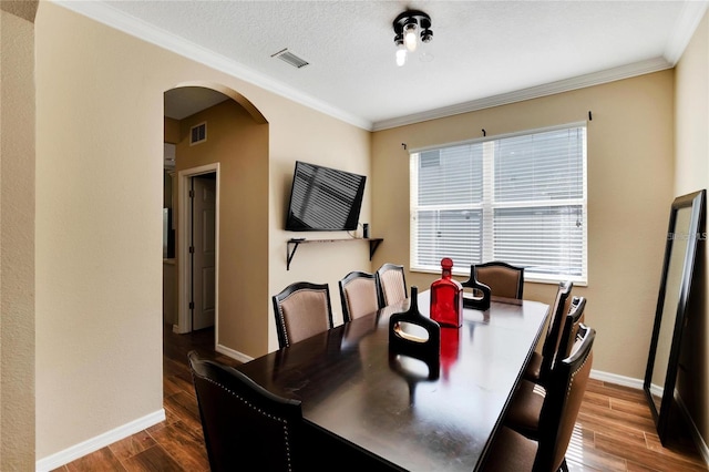 dining room with wood-type flooring and ornamental molding