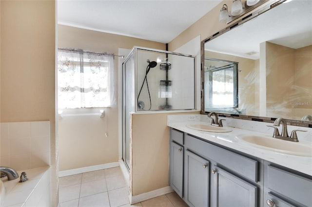 bathroom featuring walk in shower, dual bowl vanity, and tile patterned flooring