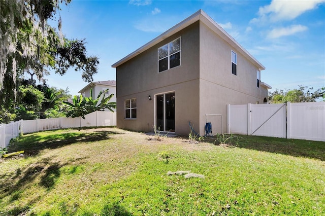 rear view of property with a yard