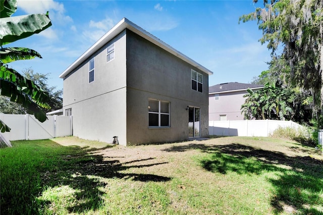 back of house featuring a yard