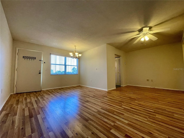 interior space featuring a textured ceiling, ceiling fan with notable chandelier, and hardwood / wood-style floors