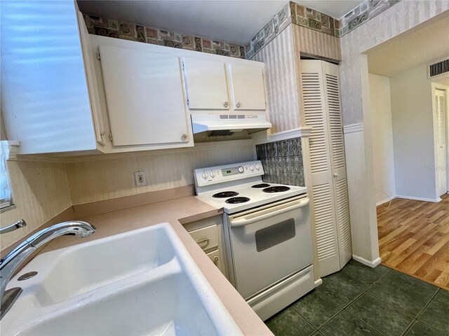 kitchen featuring white cabinets, sink, dark hardwood / wood-style flooring, and electric range