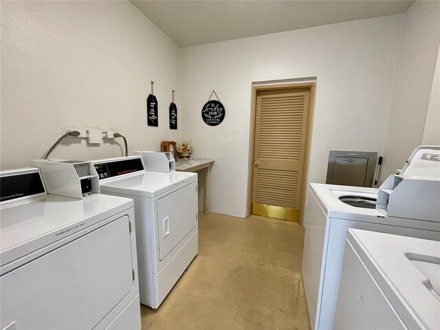 clothes washing area featuring independent washer and dryer