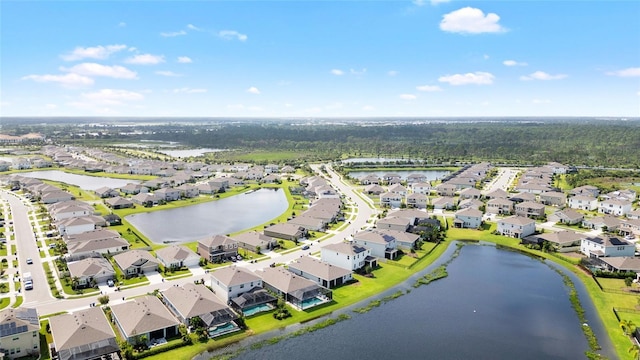 bird's eye view featuring a water view and a residential view