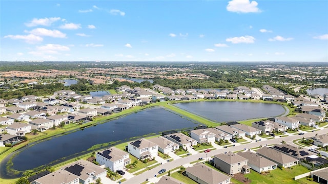 drone / aerial view with a water view and a residential view