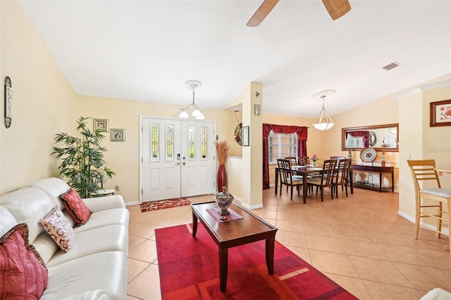 tiled living room with vaulted ceiling and ceiling fan