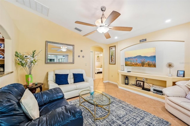 living room featuring ceiling fan, vaulted ceiling, and light tile patterned flooring