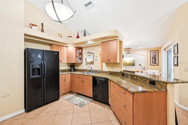 kitchen with black appliances, light tile patterned flooring, and kitchen peninsula