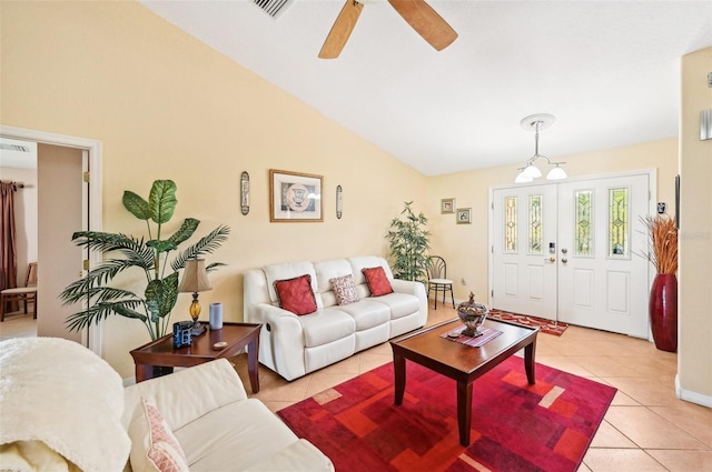 tiled living room featuring ceiling fan with notable chandelier and lofted ceiling