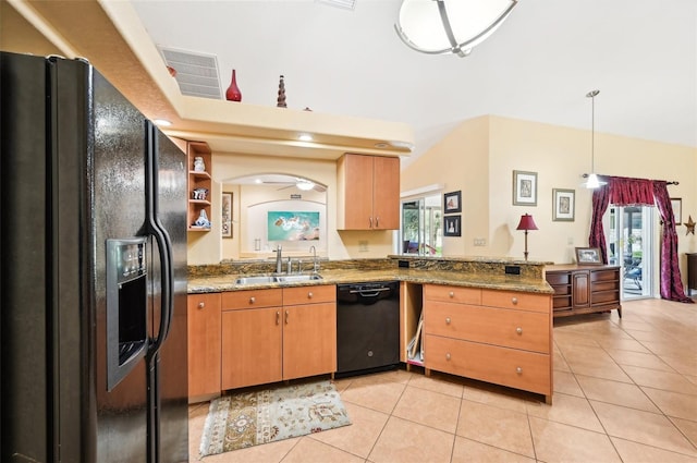 kitchen featuring kitchen peninsula, light stone counters, sink, and black appliances