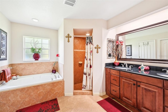 bathroom with dual bowl vanity, shower with separate bathtub, and tile patterned flooring