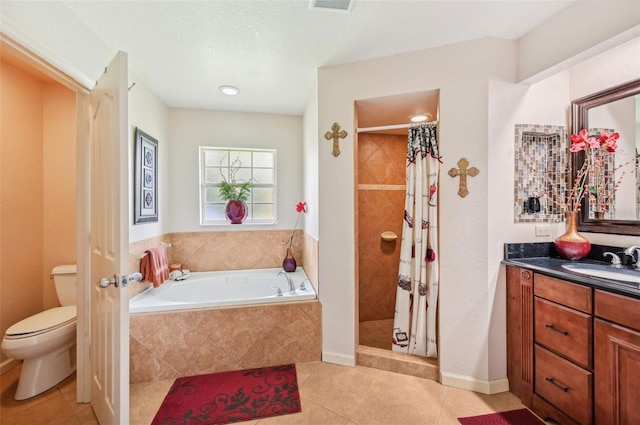 full bathroom featuring a textured ceiling, toilet, shower with separate bathtub, tile patterned flooring, and vanity