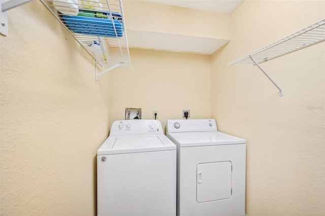 washroom featuring washer and clothes dryer