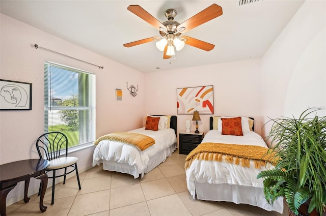 tiled bedroom featuring ceiling fan