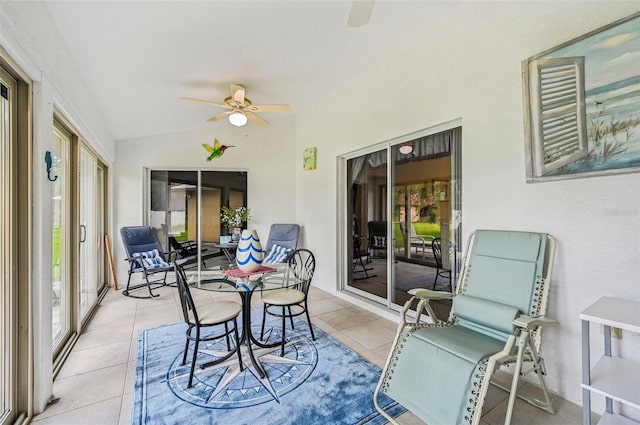 sunroom / solarium featuring ceiling fan and lofted ceiling