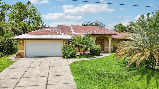 view of front of house featuring a garage and a front lawn