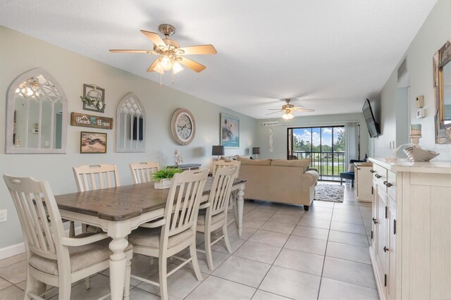 tiled dining space featuring ceiling fan