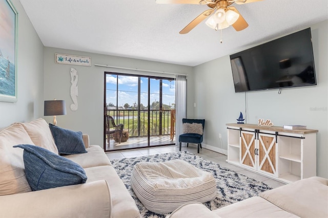 tiled living room with a textured ceiling and ceiling fan