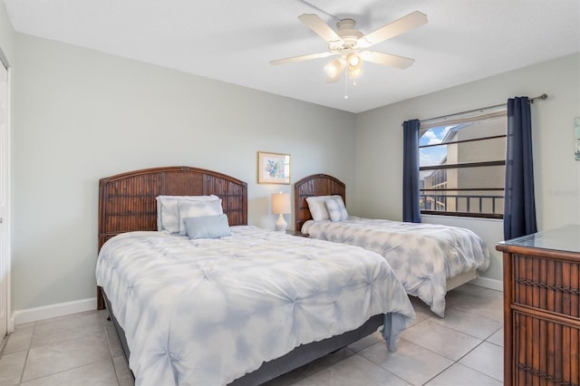 tiled bedroom featuring ceiling fan