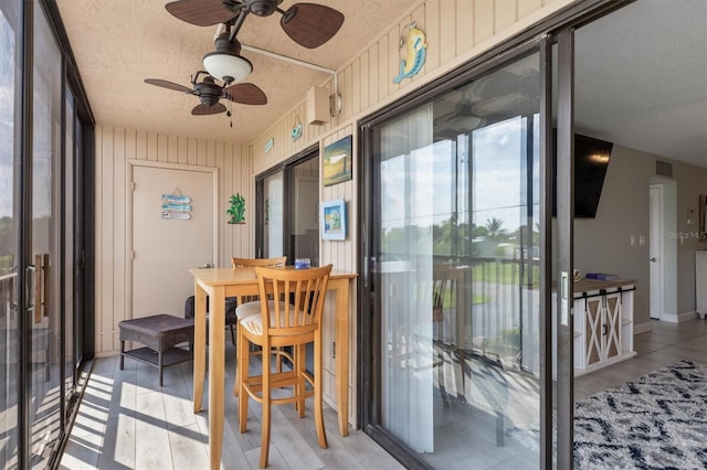 sunroom / solarium with ceiling fan