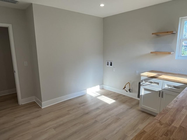 laundry room featuring light wood-type flooring