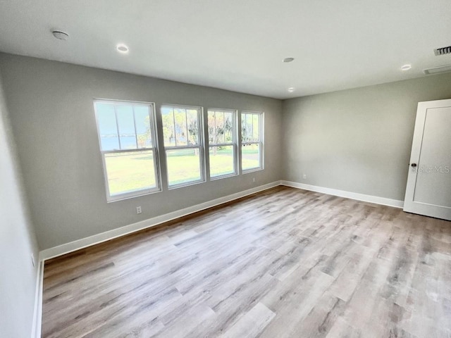 empty room with light hardwood / wood-style floors