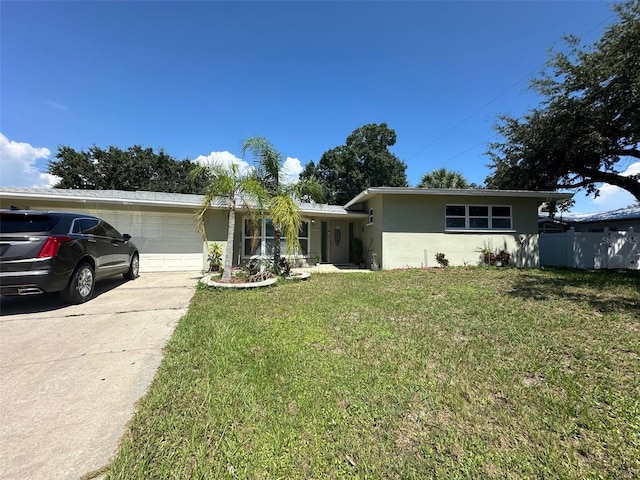 single story home featuring a front yard and a garage