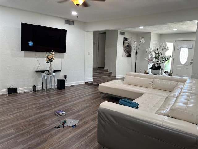 living room with ceiling fan and dark wood-type flooring