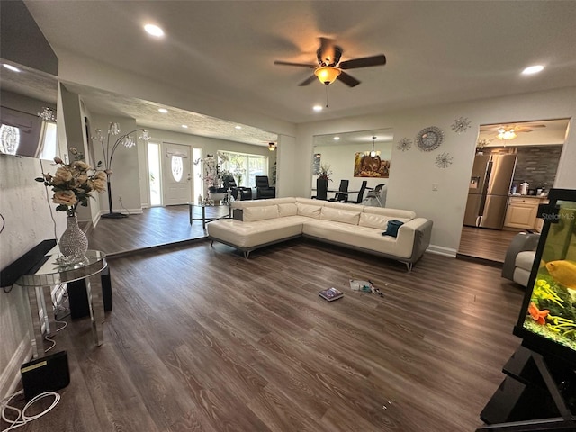 living room featuring dark hardwood / wood-style flooring and ceiling fan