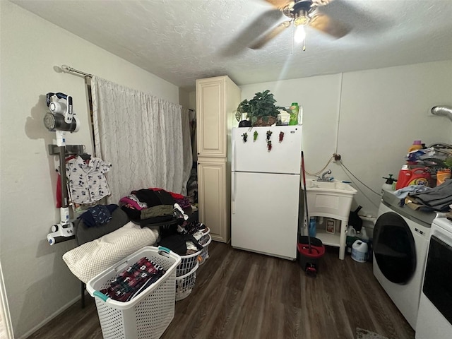 clothes washing area featuring ceiling fan, dark hardwood / wood-style flooring, washer / clothes dryer, and cabinets