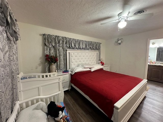 bedroom with a textured ceiling, ceiling fan, hardwood / wood-style flooring, and ensuite bathroom