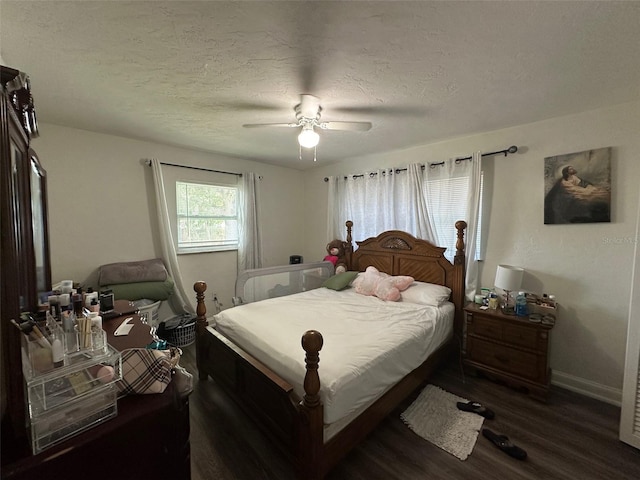 bedroom featuring ceiling fan, dark wood-type flooring, and a textured ceiling