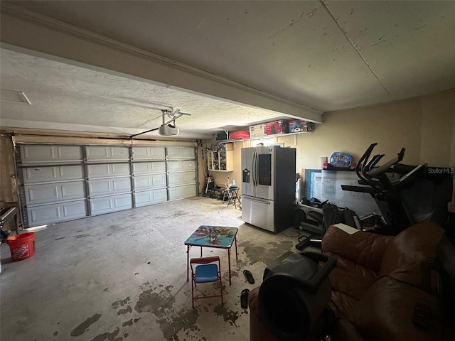 garage featuring stainless steel fridge and a garage door opener