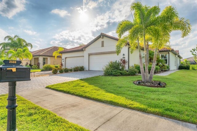 mediterranean / spanish house with a front yard and a garage