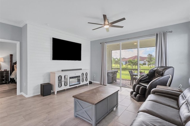 living room featuring ceiling fan, crown molding, and light wood-type flooring