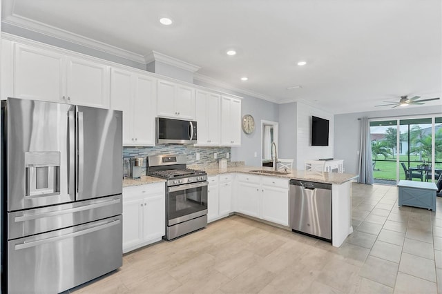 kitchen featuring sink, decorative backsplash, light stone countertops, ceiling fan, and stainless steel appliances