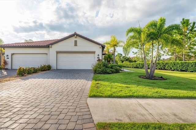 view of front of property featuring a garage and a front lawn