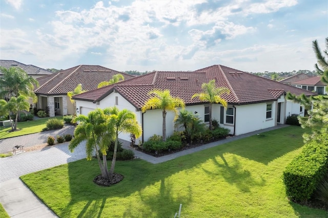 mediterranean / spanish-style house featuring a front yard