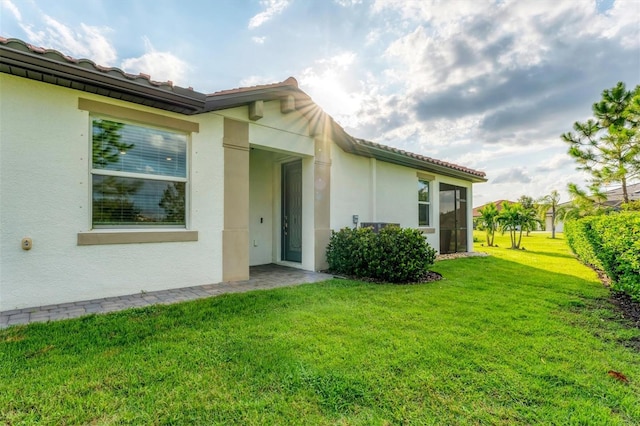 entrance to property featuring a lawn