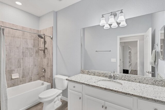 full bathroom with toilet, vanity, wood-type flooring, and shower / bathtub combination with curtain