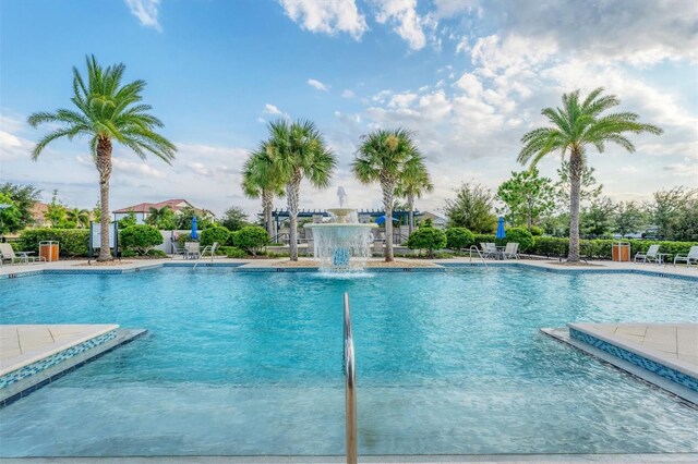 view of swimming pool with pool water feature