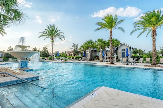 view of swimming pool featuring pool water feature and a patio