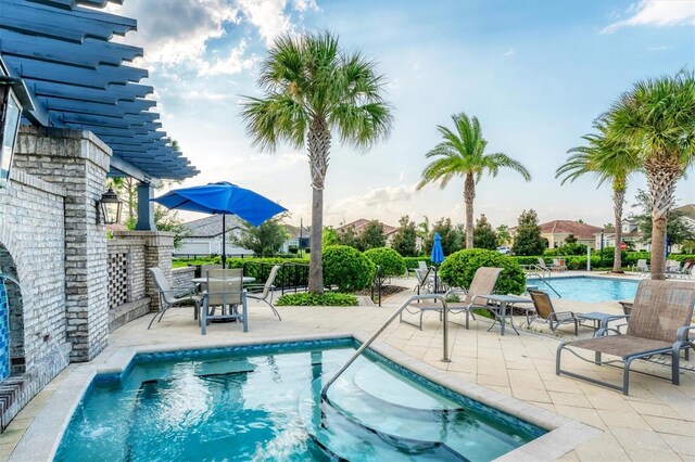 view of swimming pool featuring a pergola and a patio