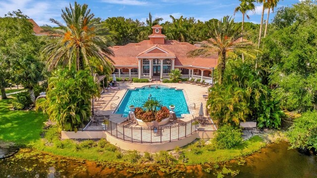 view of pool featuring a water view and a patio