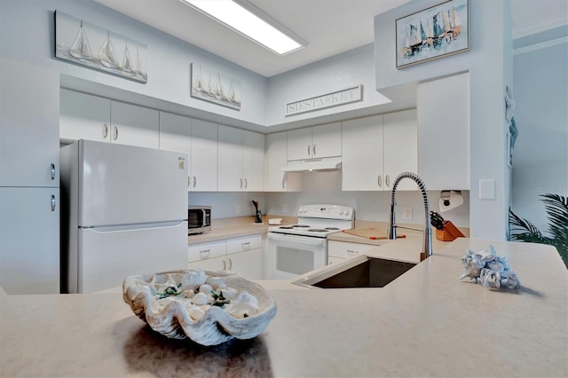 kitchen with white cabinets, white appliances, and sink