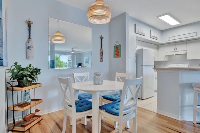 dining space featuring ceiling fan and light hardwood / wood-style floors