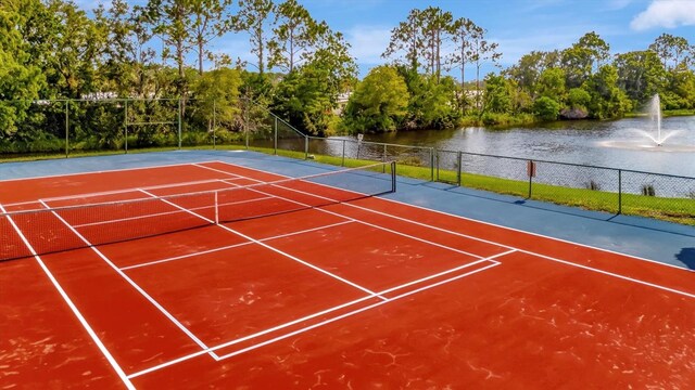 view of tennis court with a water view and basketball court