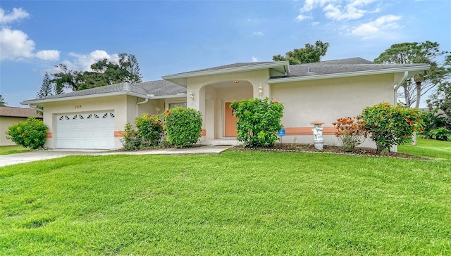 view of front of property with a garage and a front yard