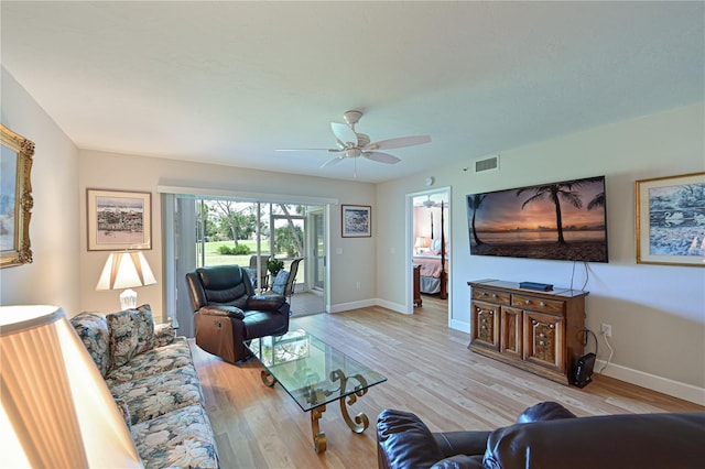 living room featuring ceiling fan and light hardwood / wood-style flooring